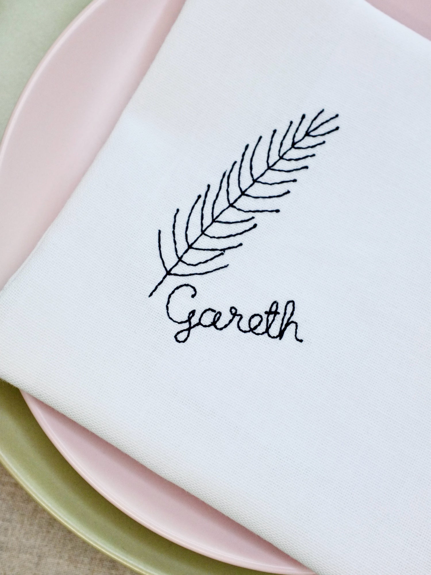 This cotton napkin features an embroidered fir branch motif with your chosen name stitched beneath. A minimalist yet festive design that adds a thoughtful and elegant detail to your Christmas or winter table