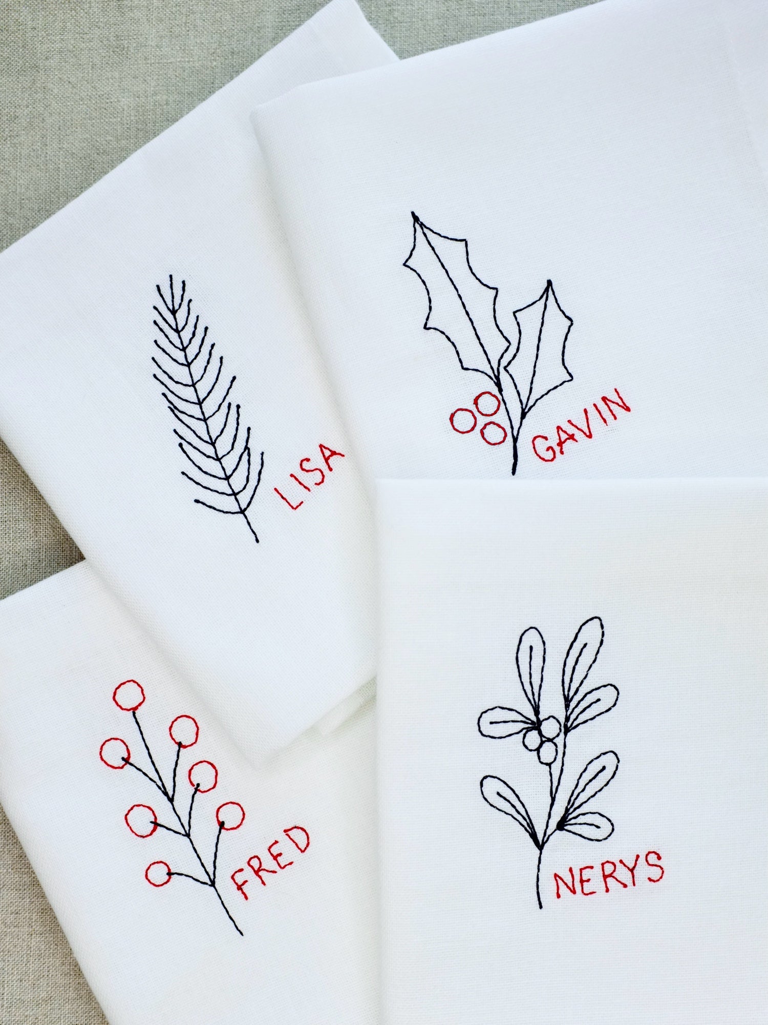 Set of 4 Personalised embroidered Christmas napkins with berry, fir, holly and mistletoe design