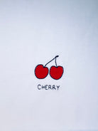 Cherry embroidery motif on white T-shirt, customizable with personal name or word in cursive script