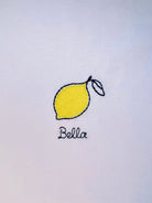 Lemon embroidery motif on white T-shirt, customizable with personal name or word in cursive script