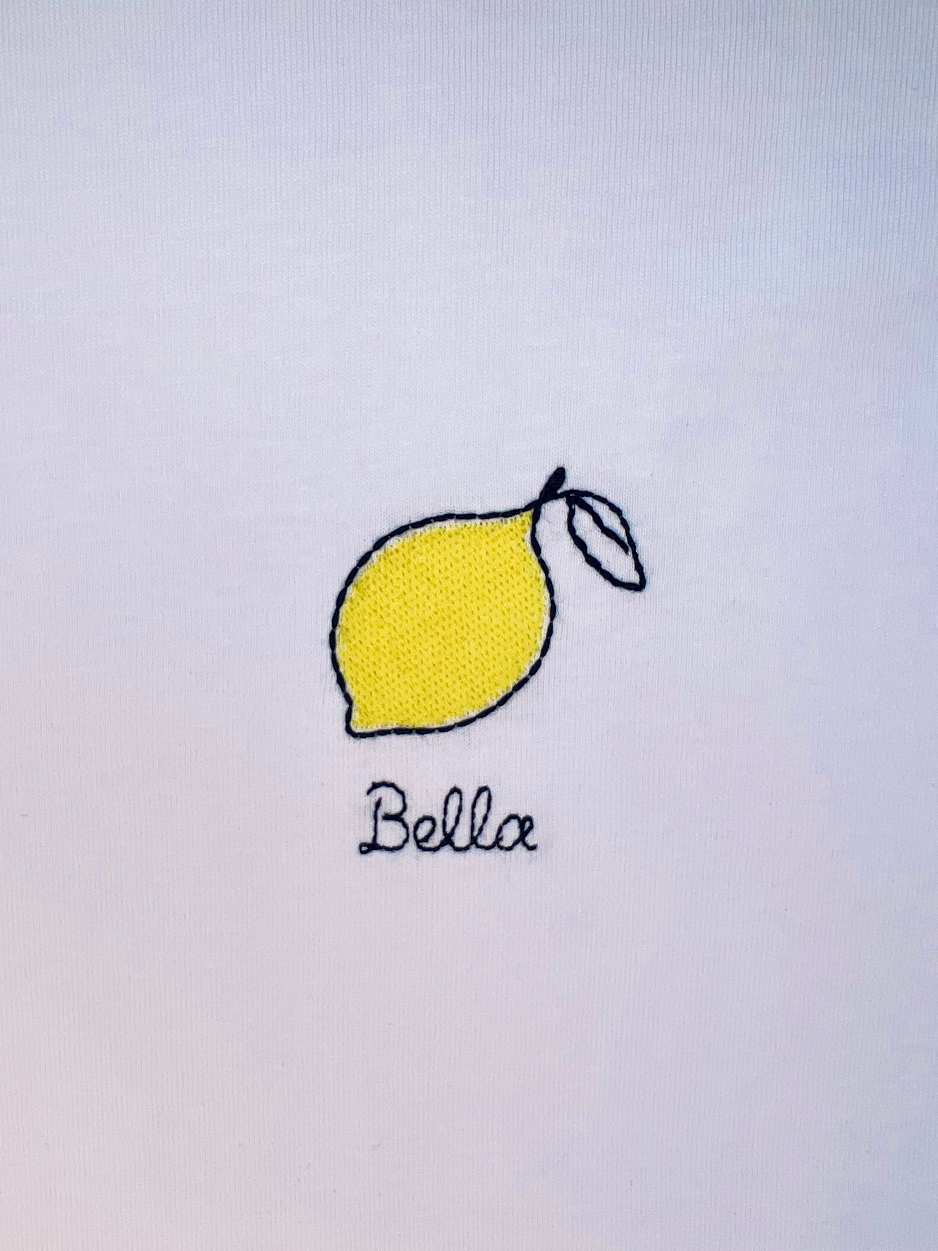 Lemon embroidery motif on white T-shirt, customizable with personal name or word in cursive script