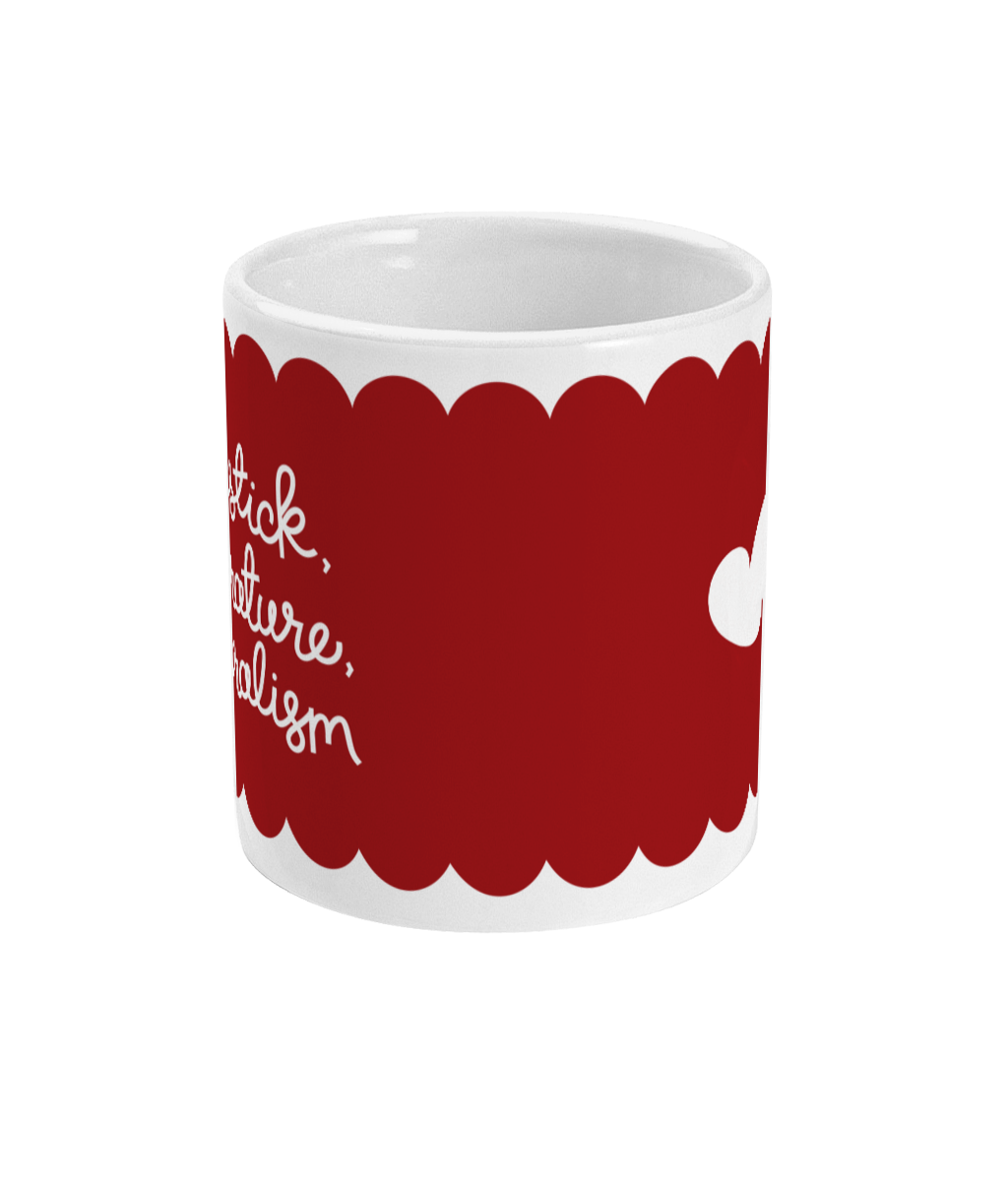White ceramic mug with a deep red scalloped design, featuring the hand-lettered phrase ‘Lipstick, Literature, Liberalism’ in white cursive. A small white heart is on the reverse side.