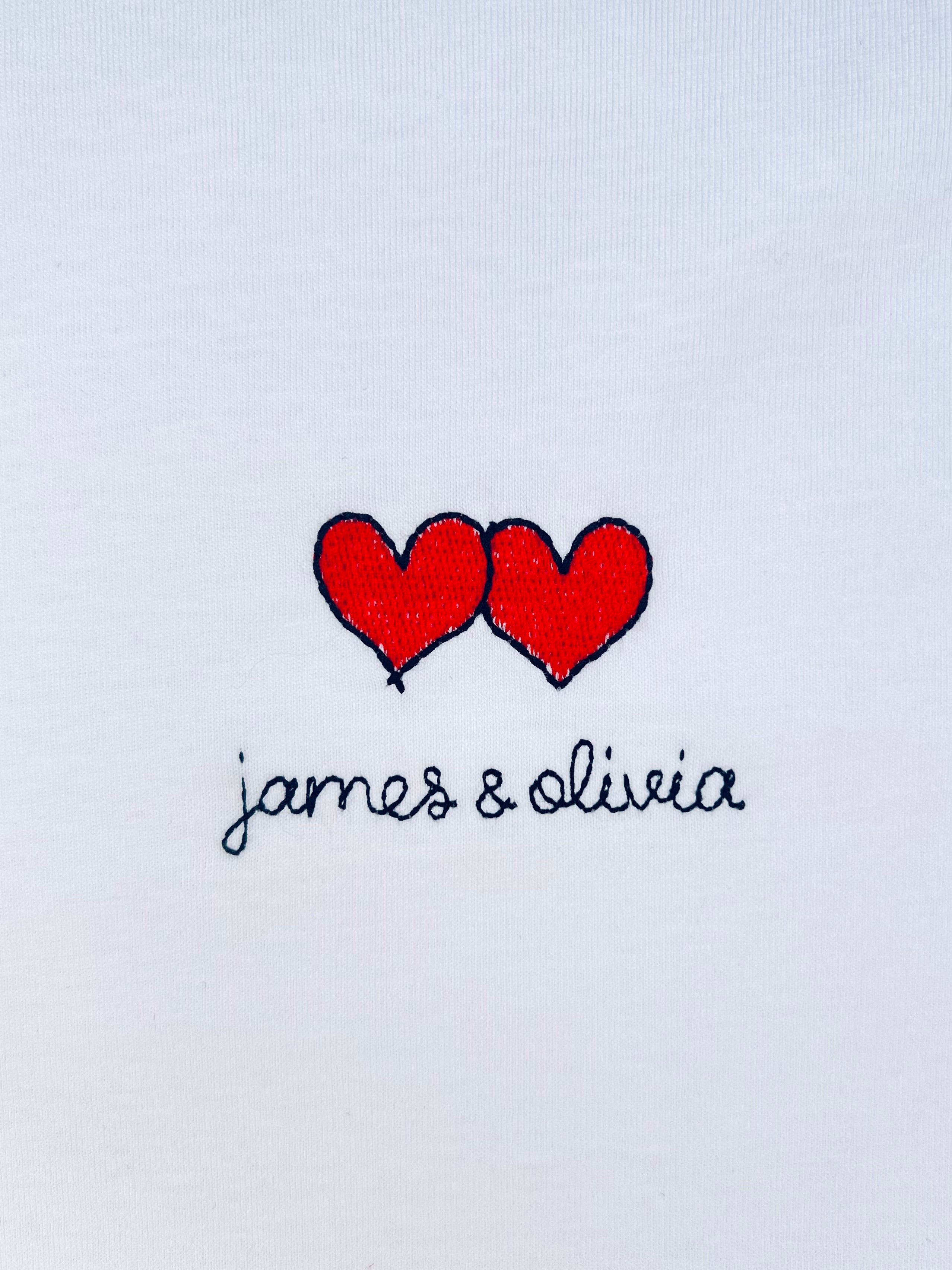 Two hearts embroidery motif on white T-shirt with custom names, perfect for personalized gifts and couples