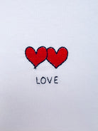 Two hearts embroidery motif on white T-shirt with custom names, perfect for personalised gifts and couples