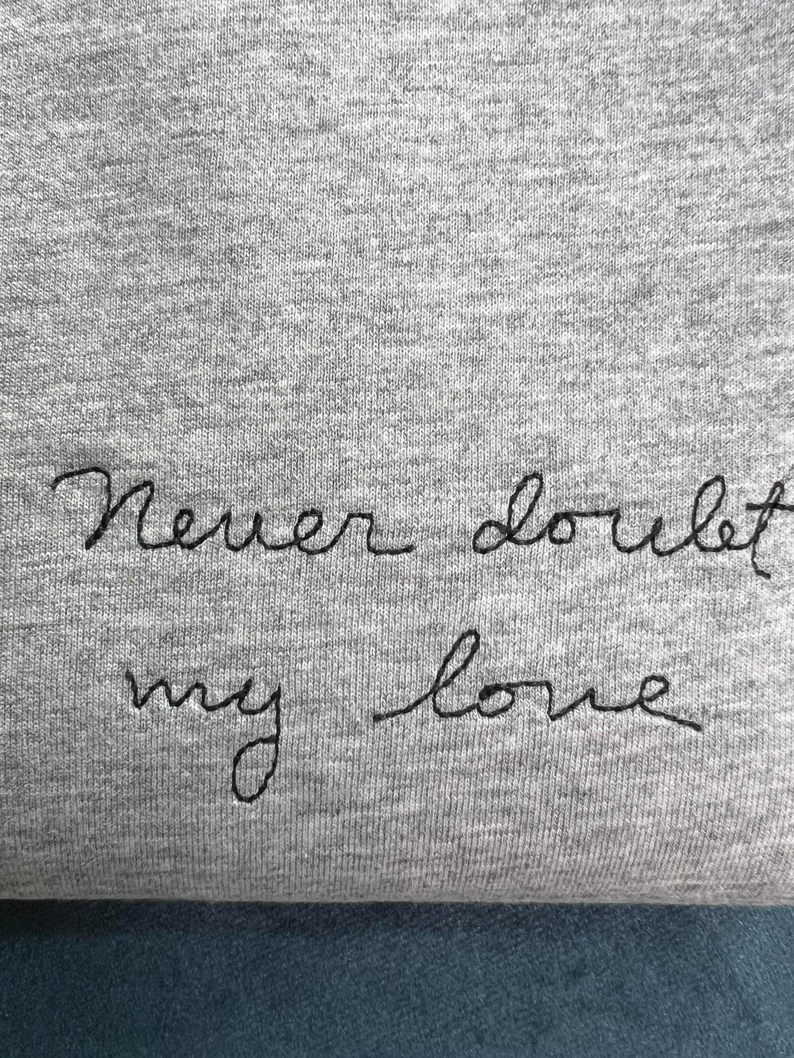 grey t-shirt with 'never doubt my love' embroidered in black thread, custom bespoke slogan embroidery