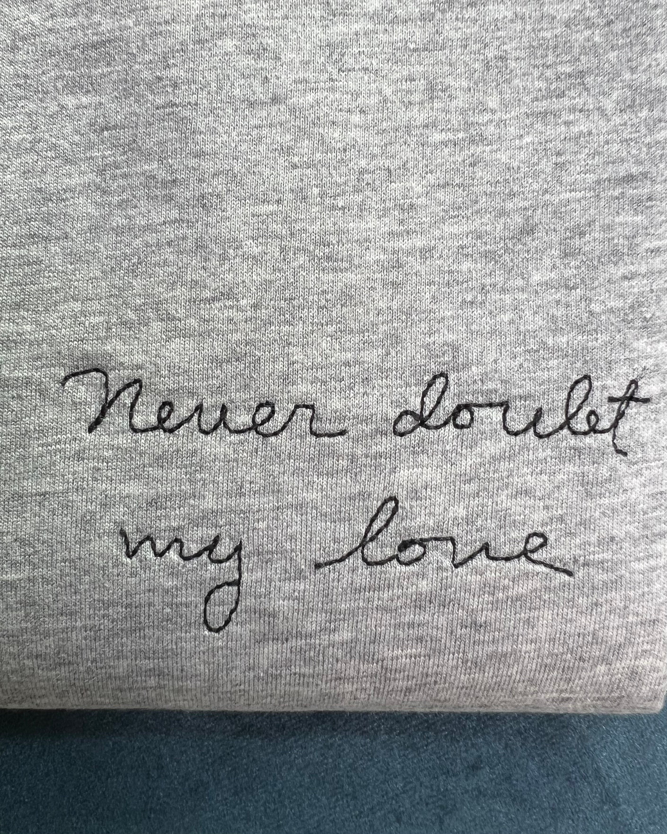 grey t-shirt with 'never doubt my love' embroidered in black thread, custom bespoke slogan embroidery
