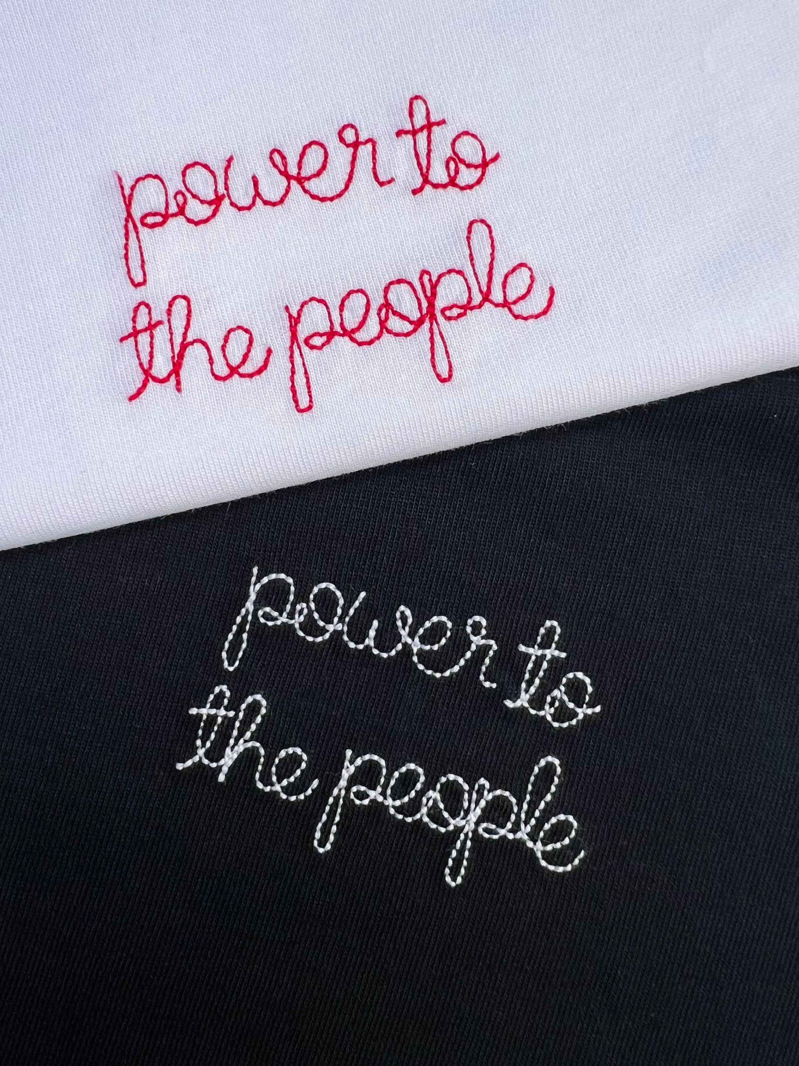 white and black t-shirt with 'power to the people' embroidered in white and red thread, custom bespoke slogan embroidery