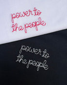white and black t-shirt with 'power to the people' embroidered in white and red thread, custom bespoke slogan embroidery