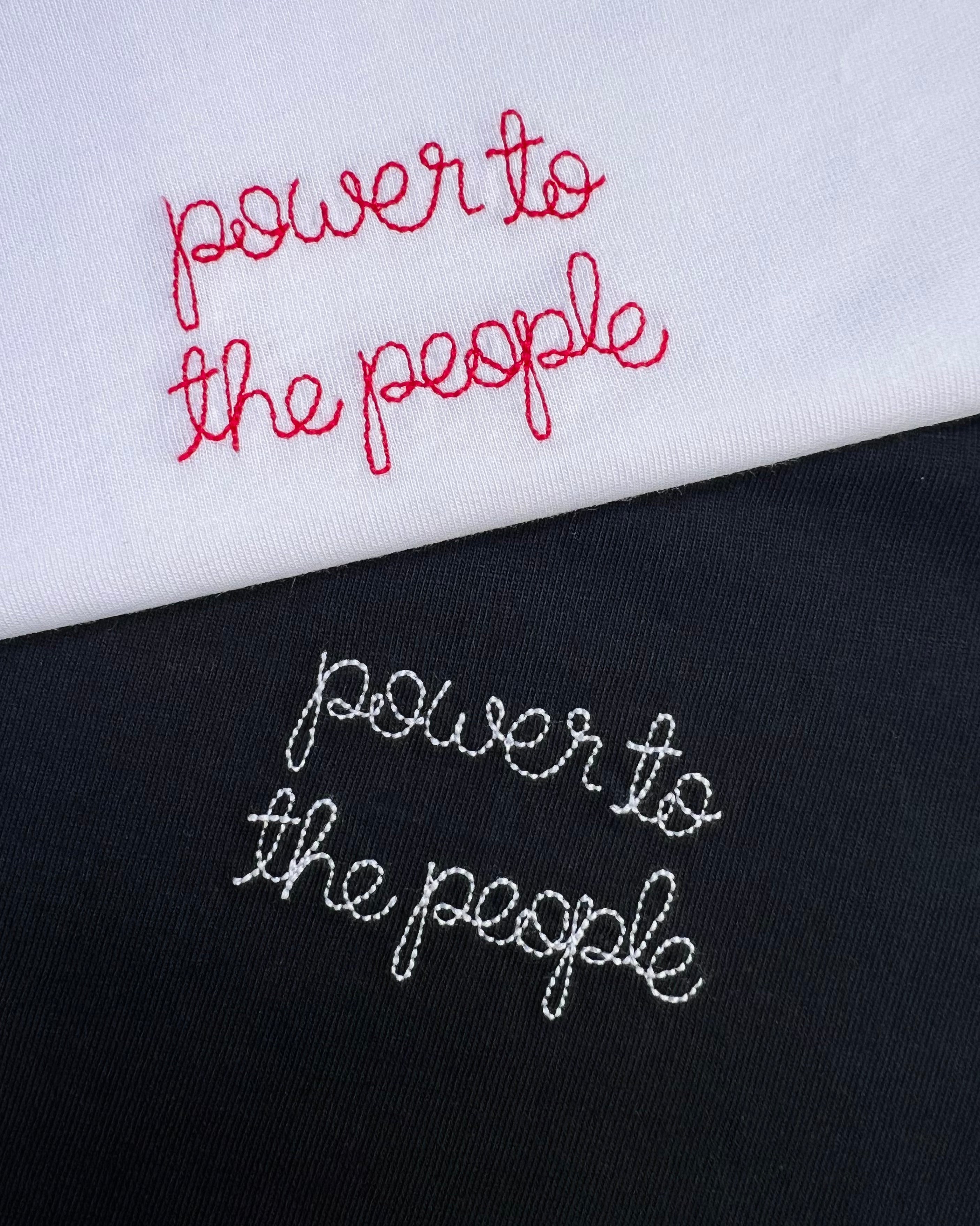 white and black t-shirt with 'power to the people' embroidered in white and red thread, custom bespoke slogan embroidery
