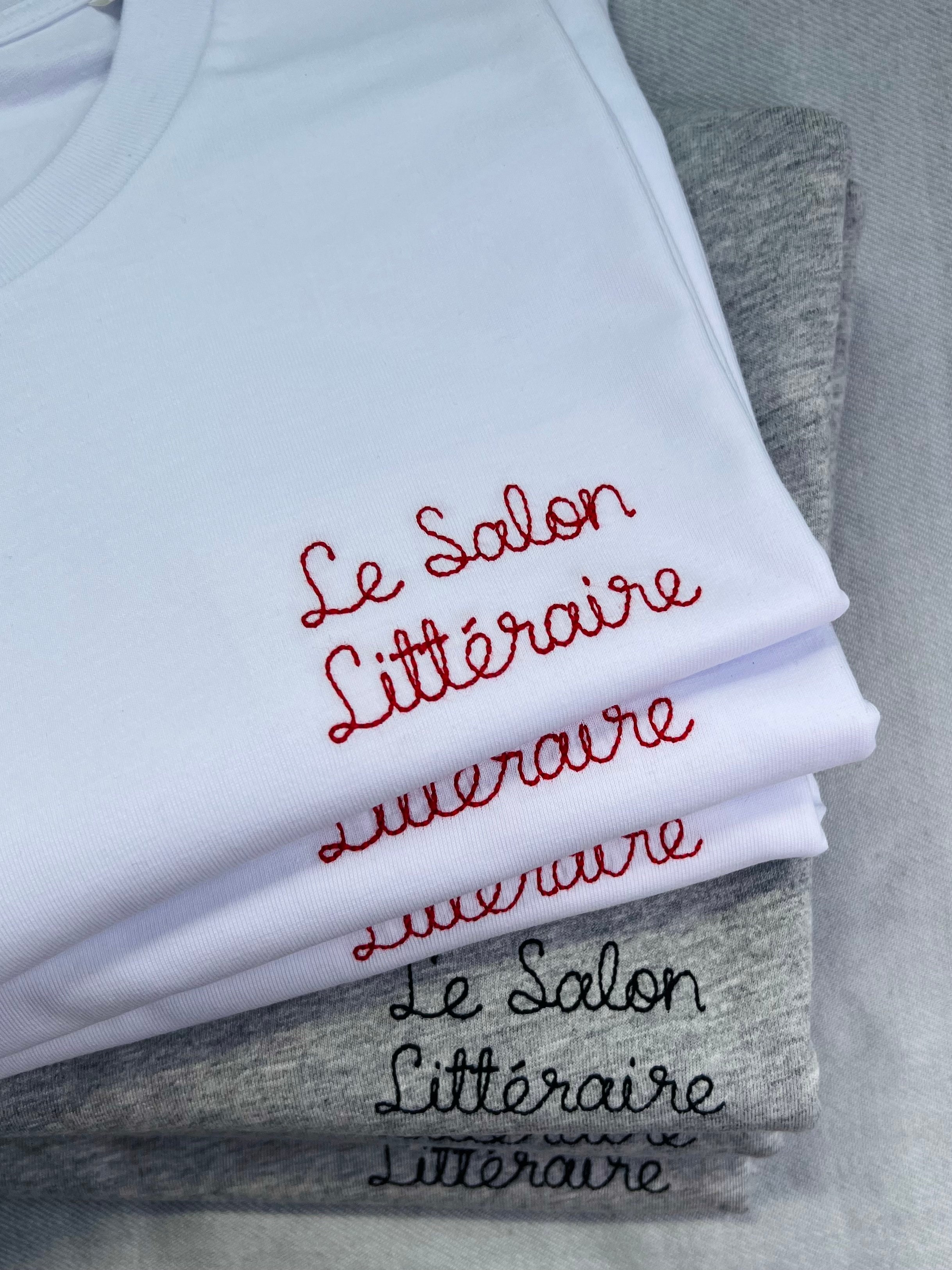 white and grey t-shirts with 'Le Salon Littéraire' embroidered in red and black thread, custom bespoke slogan embroidery