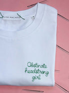 white t-shirt with 'obstinate headstrong girl' embroidered in green thread, custom bespoke slogan embroidery