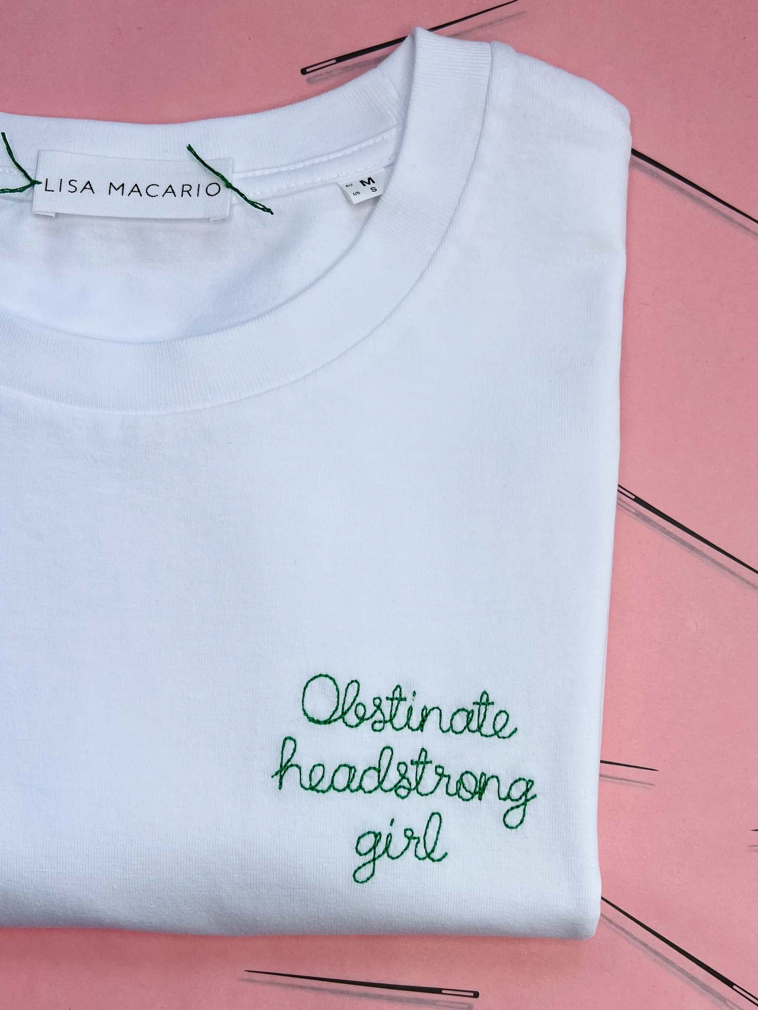 white t-shirt with 'obstinate headstrong girl' embroidered in green thread, custom bespoke slogan embroidery