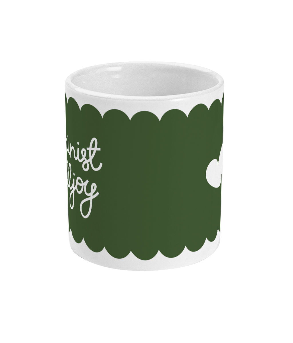 Side view of the ‘Feminist Killjoy’ mug showing hand-lettered text in white against an olive green background.