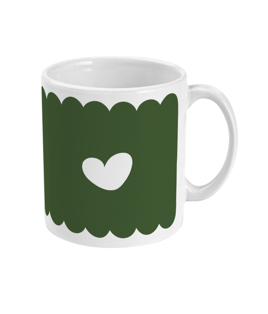 Back view of the Feminist Killjoy mug, featuring a minimalist white heart centered on an olive green scalloped background.