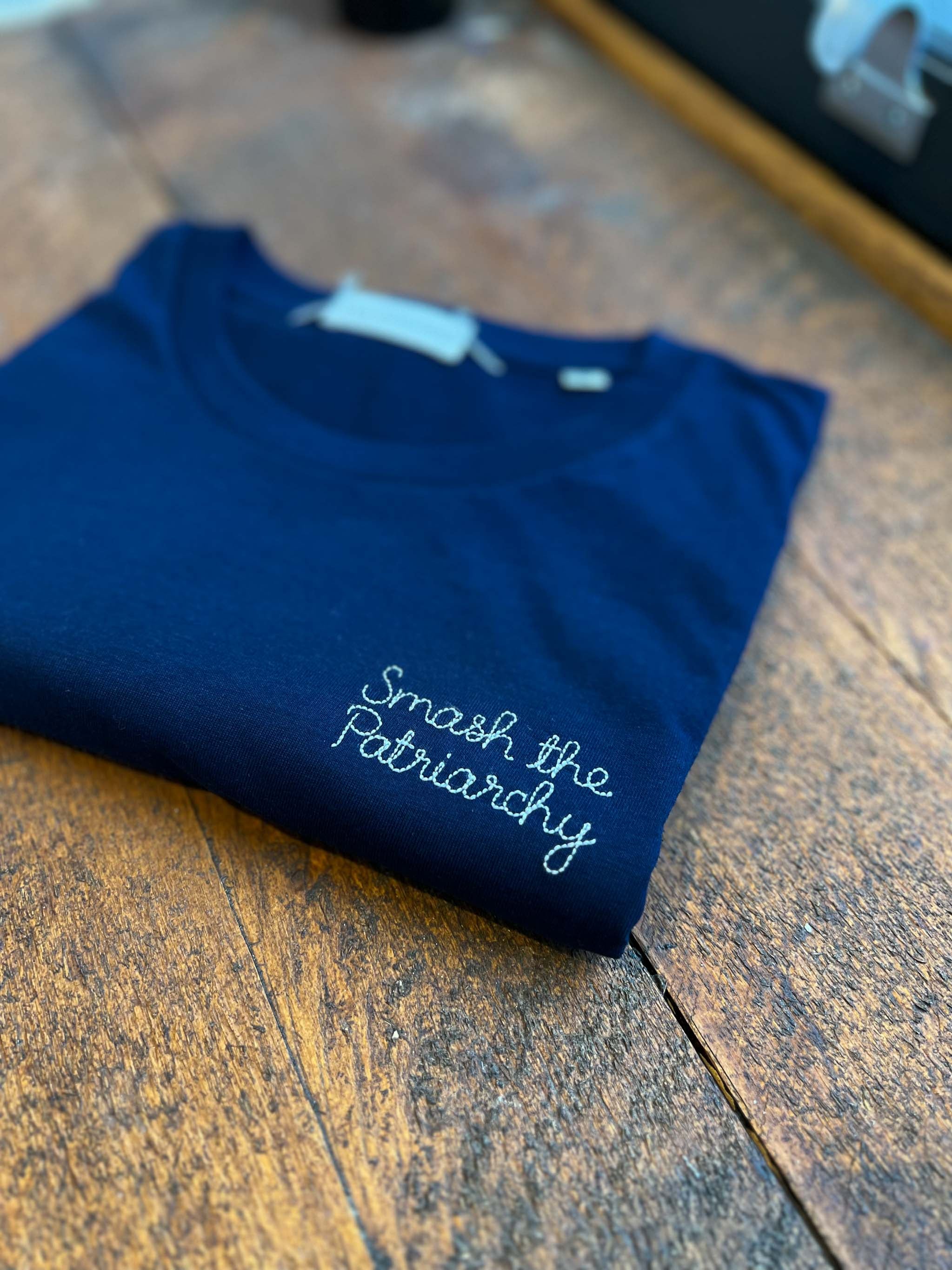 navy t-shirt with 'smash the patriarchy' embroidered in white thread, custom bespoke slogan embroidery