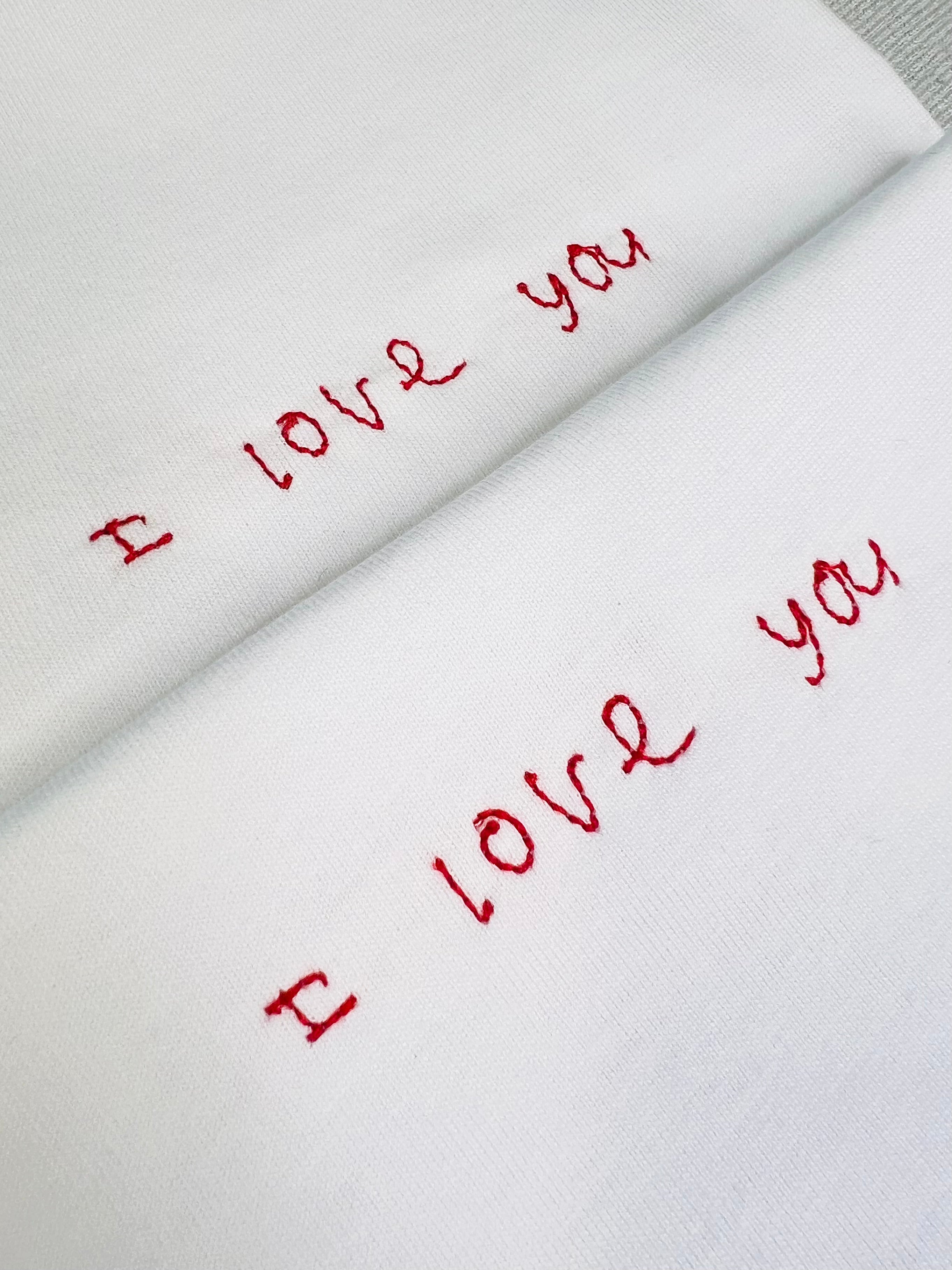 White tee with the words ‘I love you’ embroidered in red thread for a valentine’s gift custom handwriting 