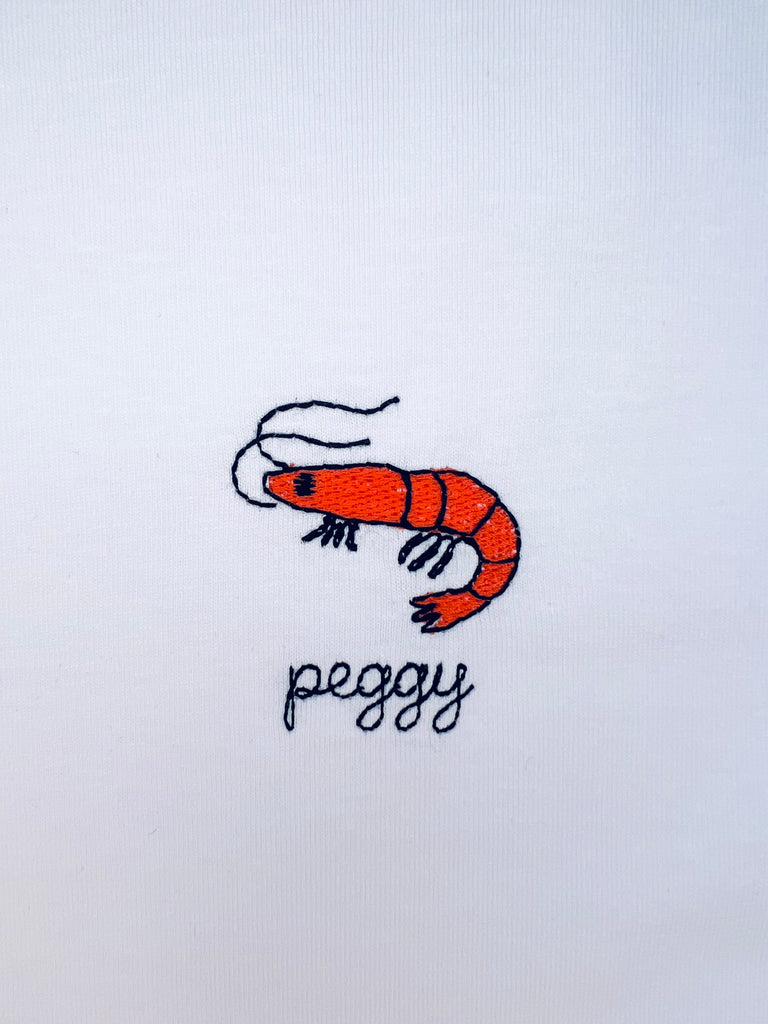 Shrimp embroidery motif on T-shirt with custom name option, ideal for seafood lovers or coastal theme