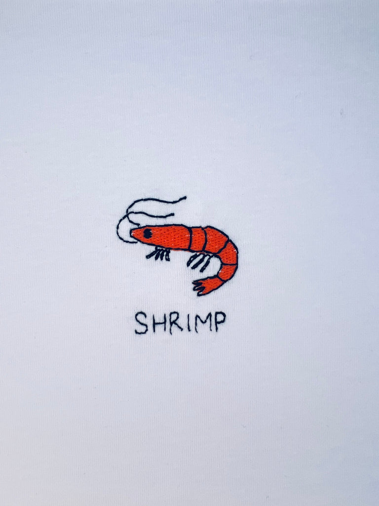 Shrimp embroidery motif on T-shirt with custom name option, ideal for seafood lovers or coastal theme